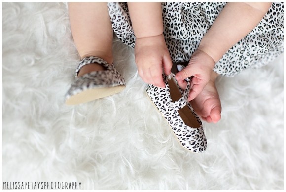 "baby trying on shoes image"