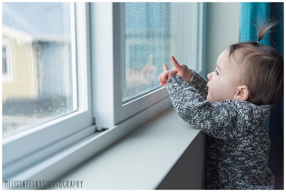 "baby looking out the window image"